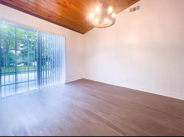 a view of a room with wooden floor and windows