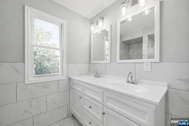 a bathroom with a sink double vanity and mirror