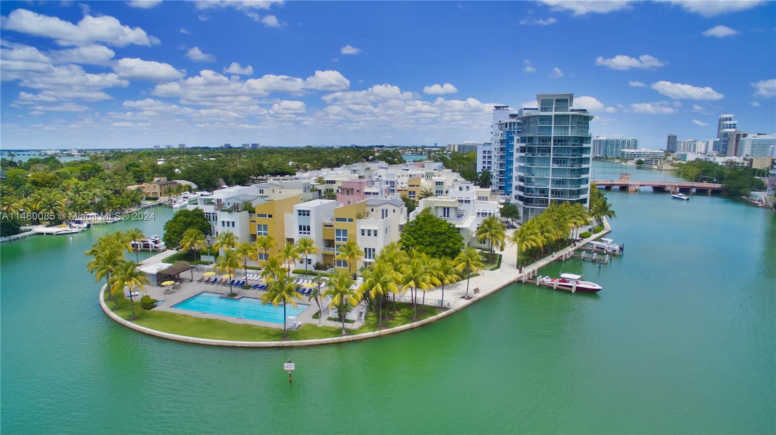 6010 Aqua Path Miami Beach, FL 33141 - Photo 12 of 65 a swimming pool with outdoor seating and a lake view