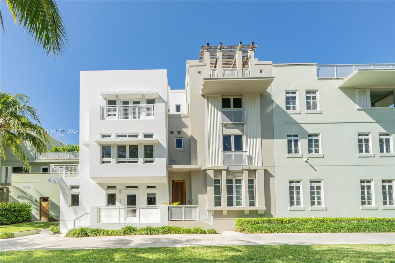 6010 Aqua Path Miami Beach, FL 33141 - Photo 13 of 65 a view of a building with a yard