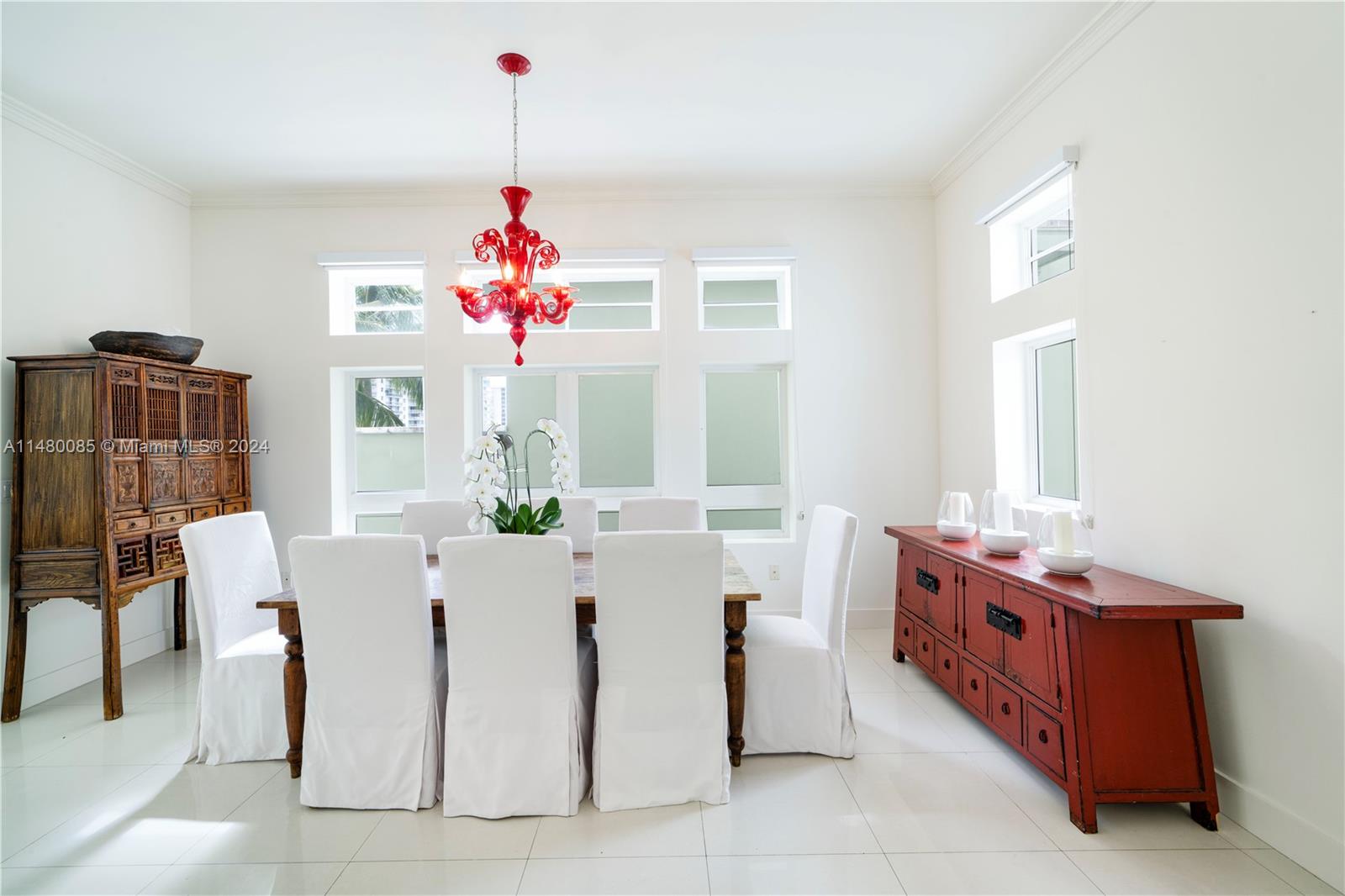 6010 Aqua Path Miami Beach, FL 33141 - Photo 17 of 65 a very nice looking dining room with a window and chandelier