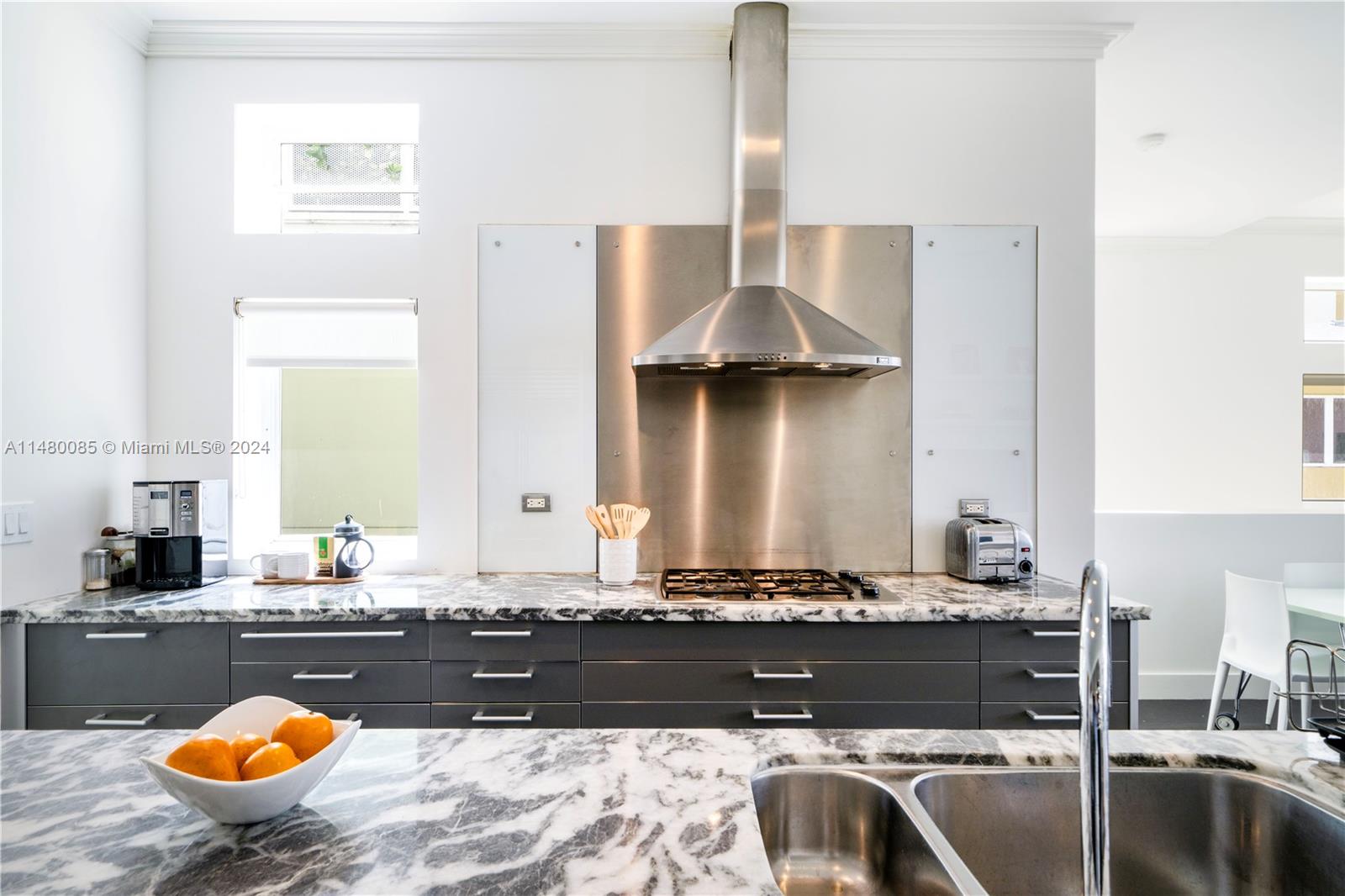 6010 Aqua Path Miami Beach, FL 33141 - Photo 21 of 65 a bathroom with a granite countertop sink and a bathtub