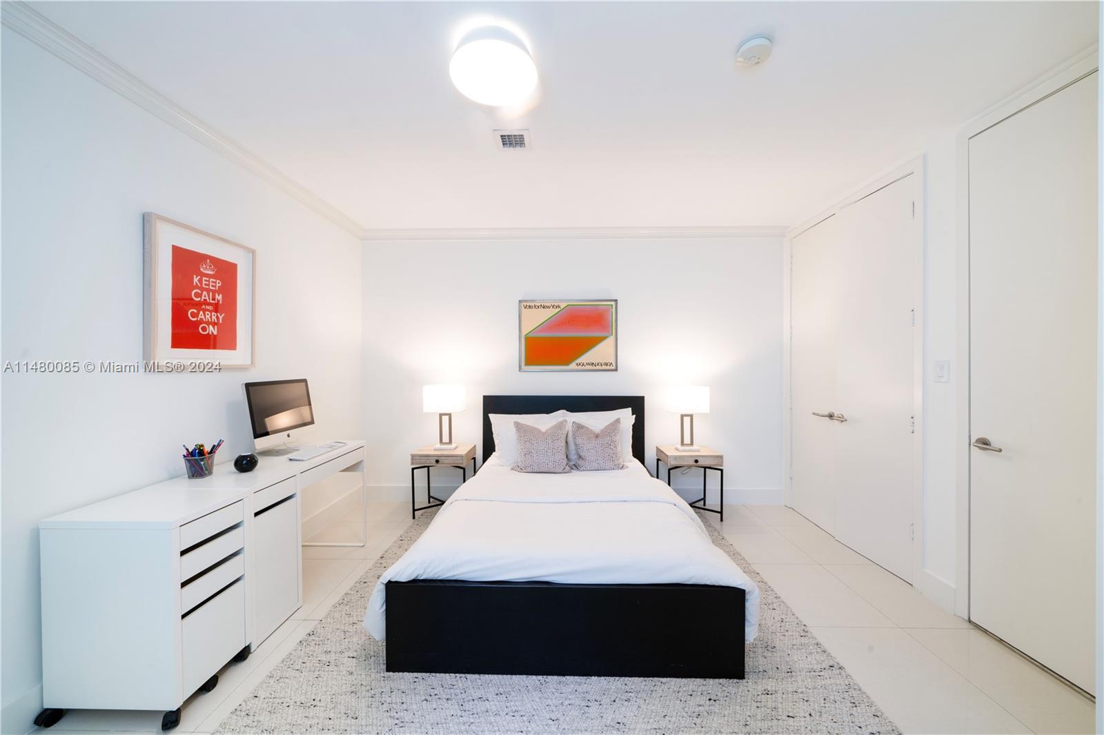 6010 Aqua Path Miami Beach, FL 33141 - Photo 27 of 65 a bedroom with a bed and a flat screen tv