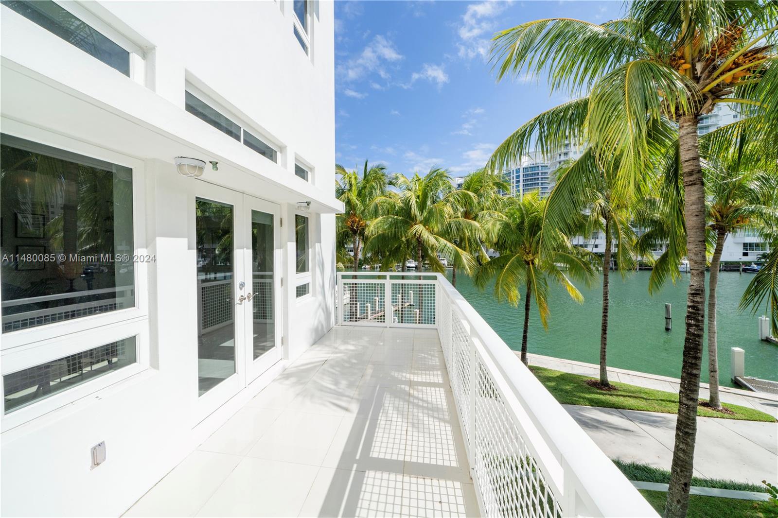 6010 Aqua Path Miami Beach, FL 33141 - Photo 29 of 65 a balcony with view of palm trees