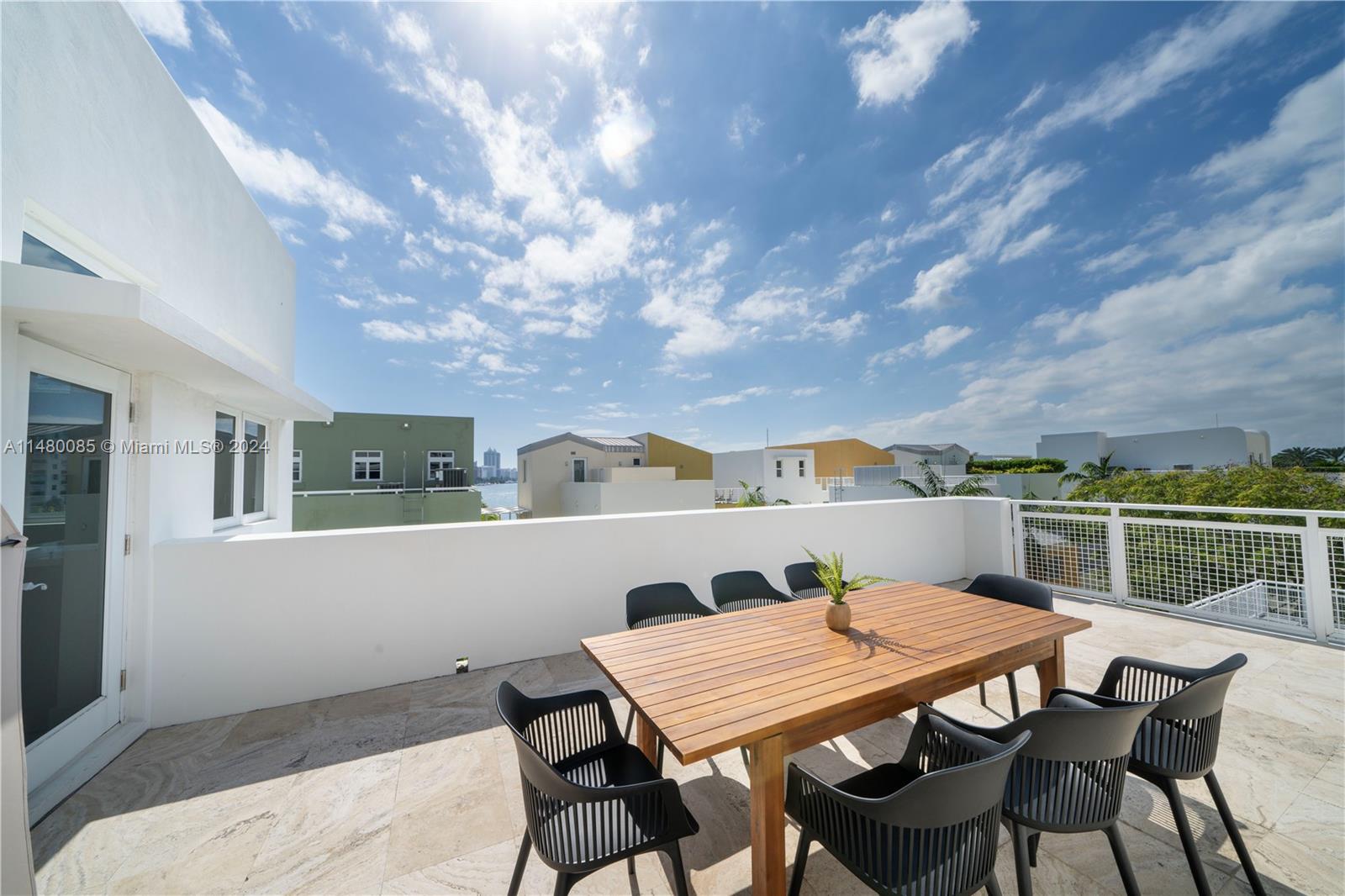 6010 Aqua Path Miami Beach, FL 33141 - Photo 36 of 65 a terrace of a house with outdoor seating