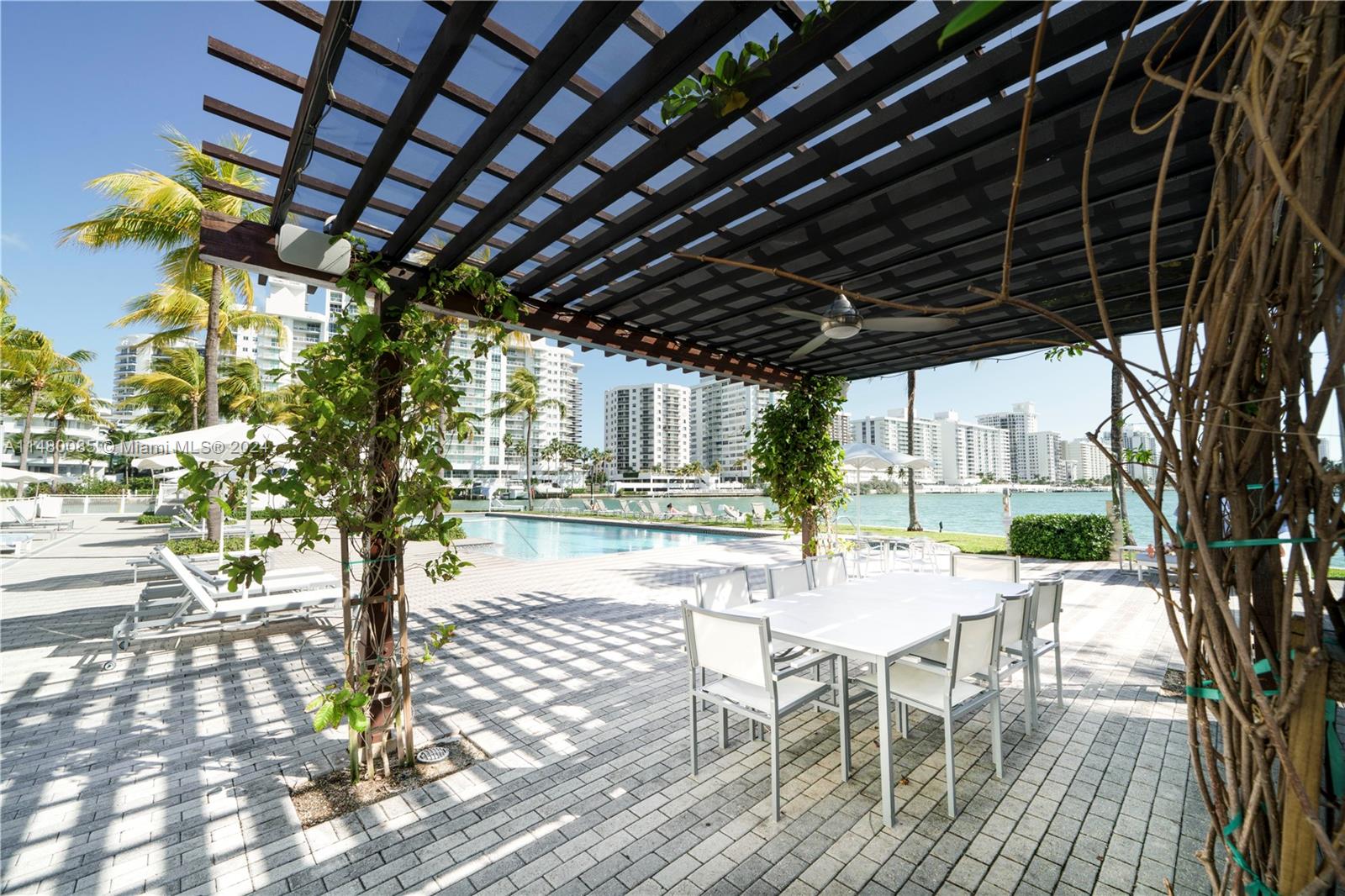 6010 Aqua Path Miami Beach, FL 33141 - Photo 50 of 65 a patio with glass top table and chairs