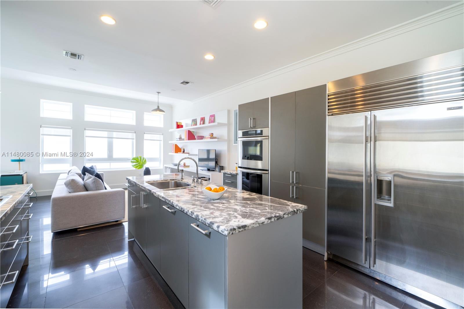 6010 Aqua Path Miami Beach, FL 33141 - Photo 6 of 65 a kitchen with stainless steel appliances granite countertop a refrigerator and a stove