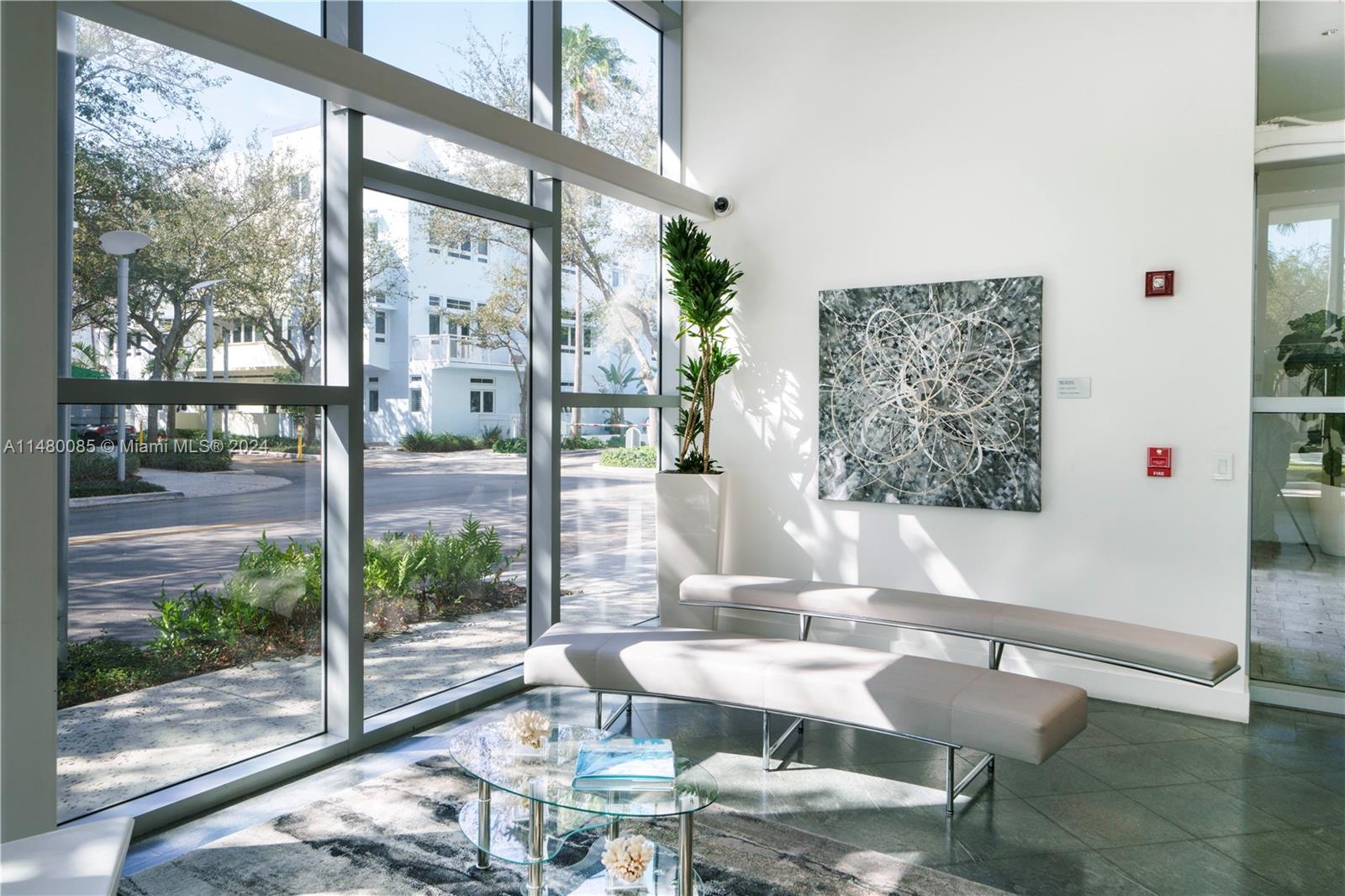 6010 Aqua Path Miami Beach, FL 33141 - Photo 61 of 65 a dining room with furniture and a floor to ceiling window