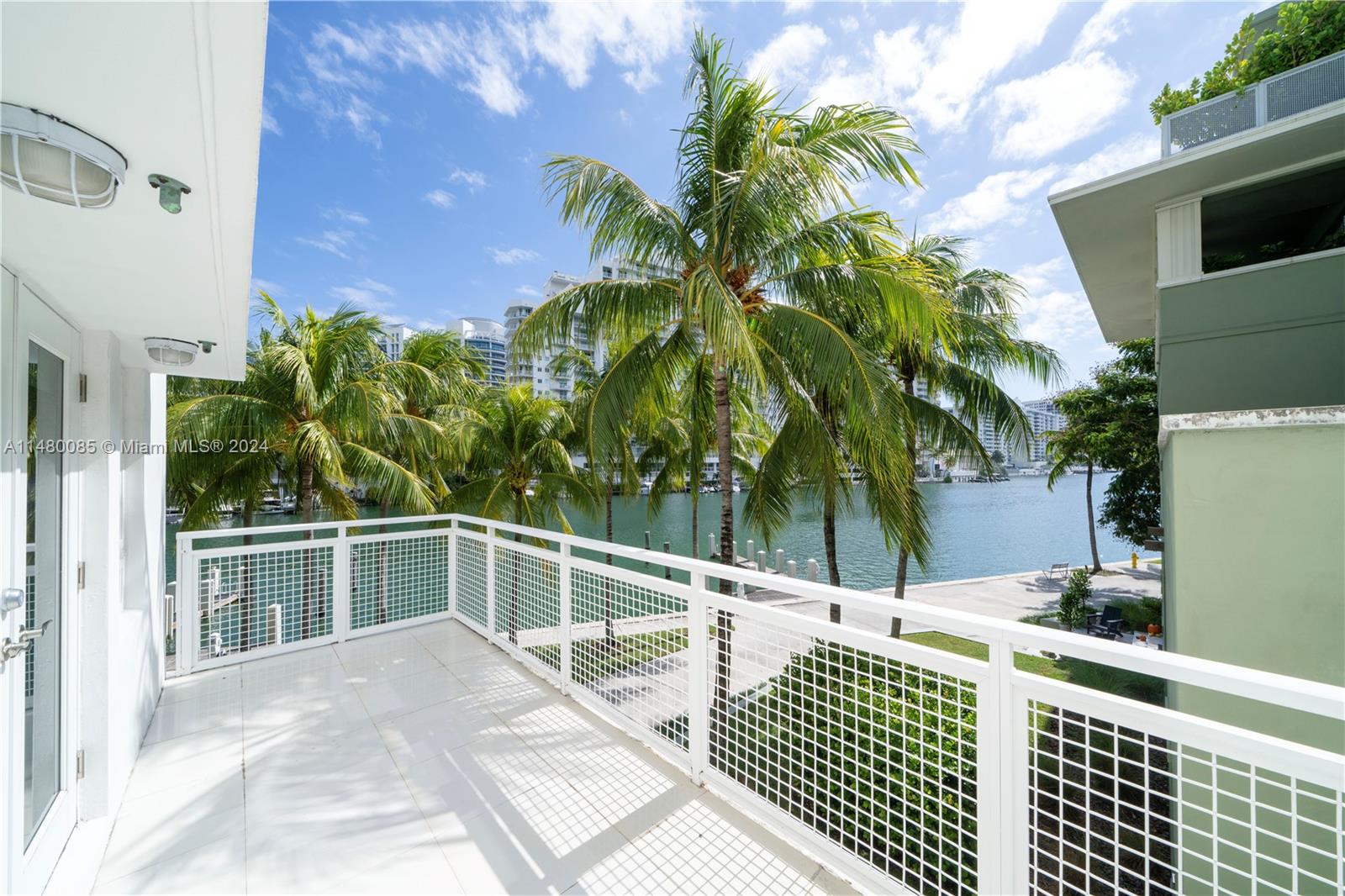 6010 Aqua Path Miami Beach, FL 33141 - Photo 7 of 65 a view of a balcony with wooden floor and potted plant