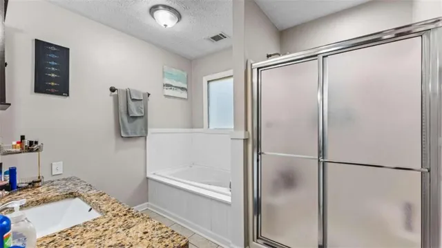 a bathroom with a bathtub and a shower