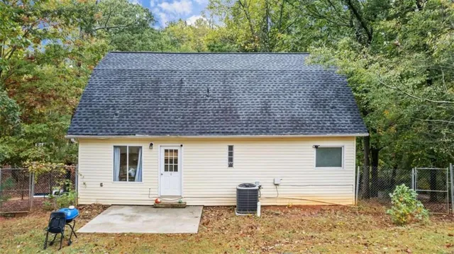 a side view of a house with a yard
