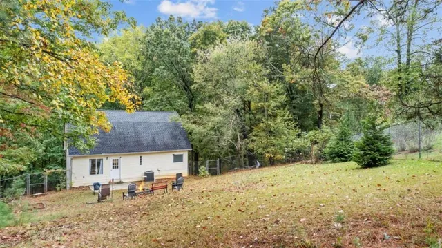 a table and chairs sitting in a backyard of a house