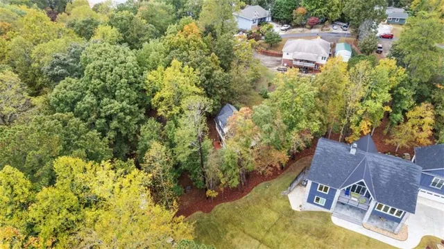 an aerial view of residential house with yard and swimming pool