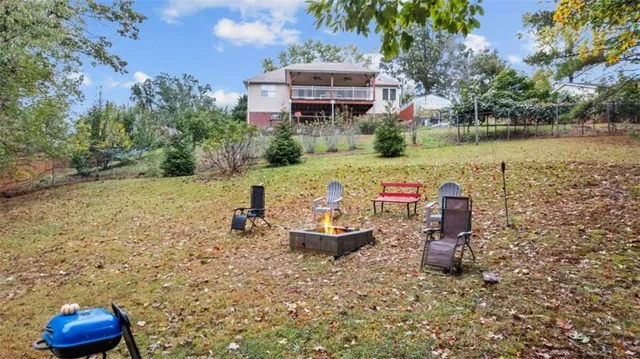 a front view of a house with a garden and lake view
