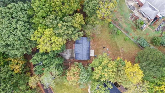 an aerial view of a house with a yard