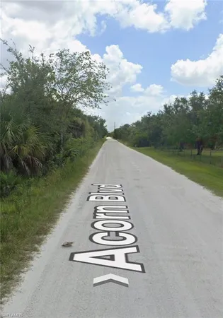 a view of a street with a yard