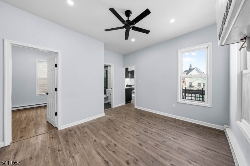 629 Magnolia Avenue Elizabeth Port, NJ 07206 - Photo 12 of 24 wooden floor in an empty room with a window