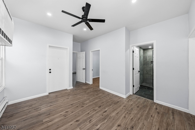 629 Magnolia Avenue Elizabeth Port, NJ 07206 - Photo 13 of 24 a view of hallway with wooden floor and ceiling fan