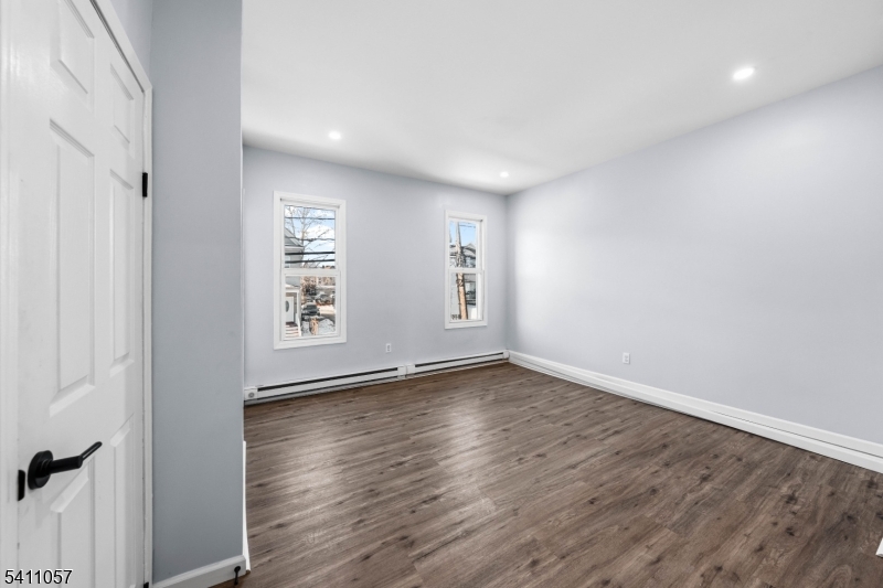 629 Magnolia Avenue Elizabeth Port, NJ 07206 - Photo 16 of 24 an empty room with wooden floor and windows