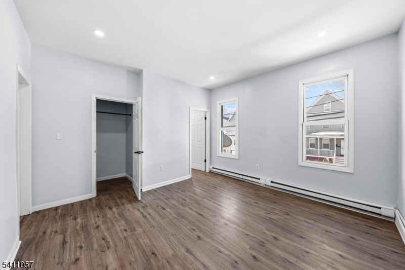 629 Magnolia Avenue Elizabeth Port, NJ 07206 - Photo 17 of 24 an empty room with wooden floor and windows