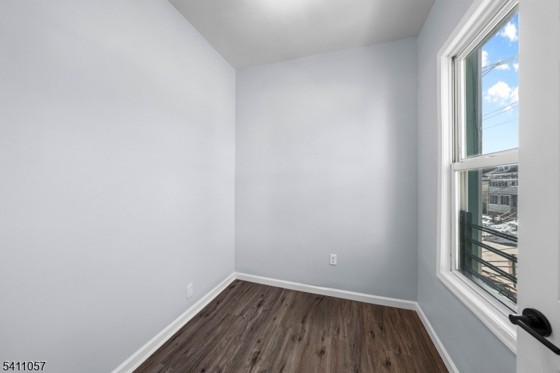 629 Magnolia Avenue Elizabeth Port, NJ 07206 - Photo 18 of 24 a view of a small space with wooden floor and a window