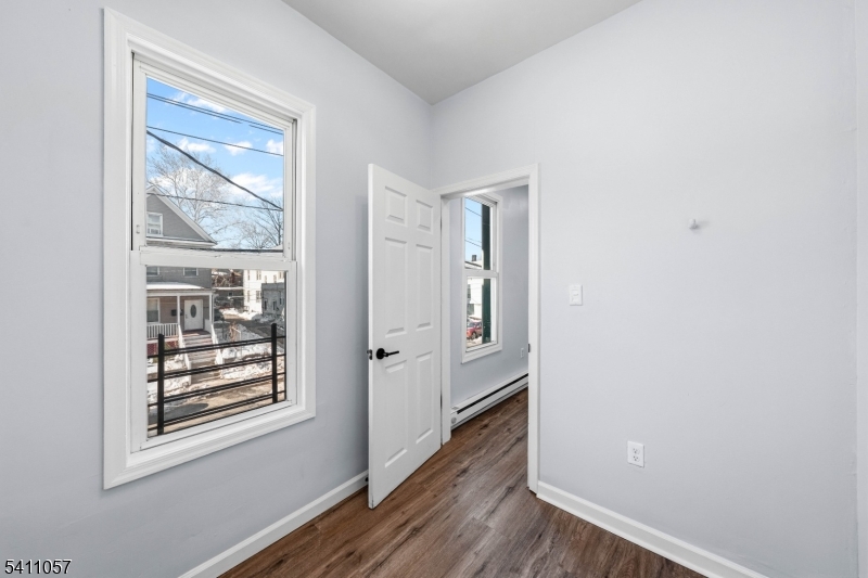 629 Magnolia Avenue Elizabeth Port, NJ 07206 - Photo 19 of 24 a view of a hallway with wooden floor and a window