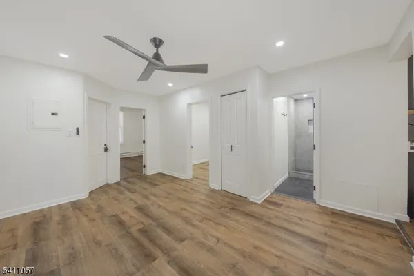 a view of empty room with wooden floor