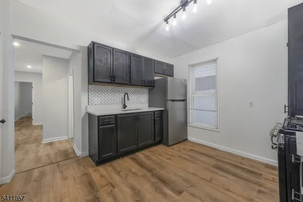 a kitchen with stainless steel appliances a refrigerator and a stove top oven