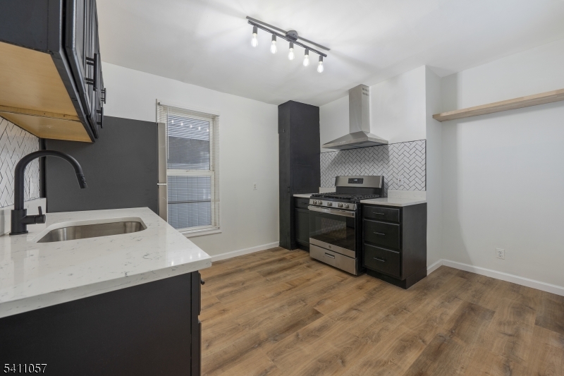 629 Magnolia Avenue Elizabeth Port, NJ 07206 - Photo 6 of 24 a kitchen with granite countertop a sink stove and refrigerator