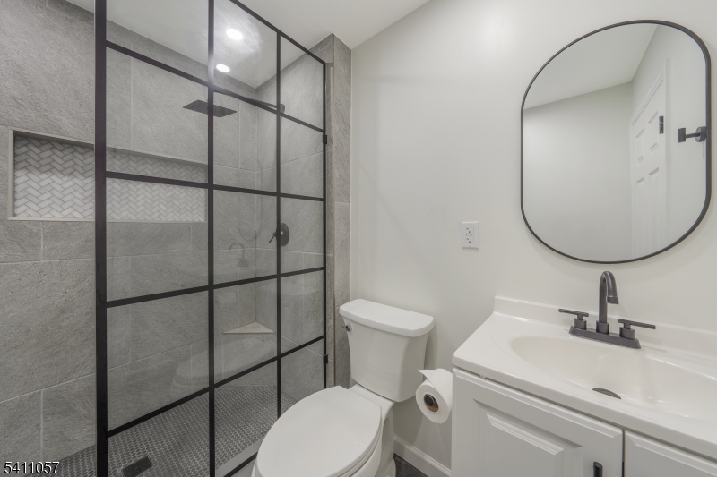 629 Magnolia Avenue Elizabeth Port, NJ 07206 - Photo 9 of 24 a bathroom with a sink toilet and a mirror