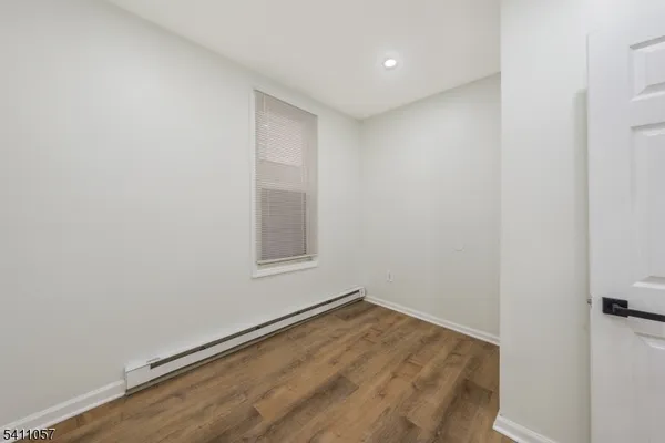 a view of a room with wooden floor and natural light