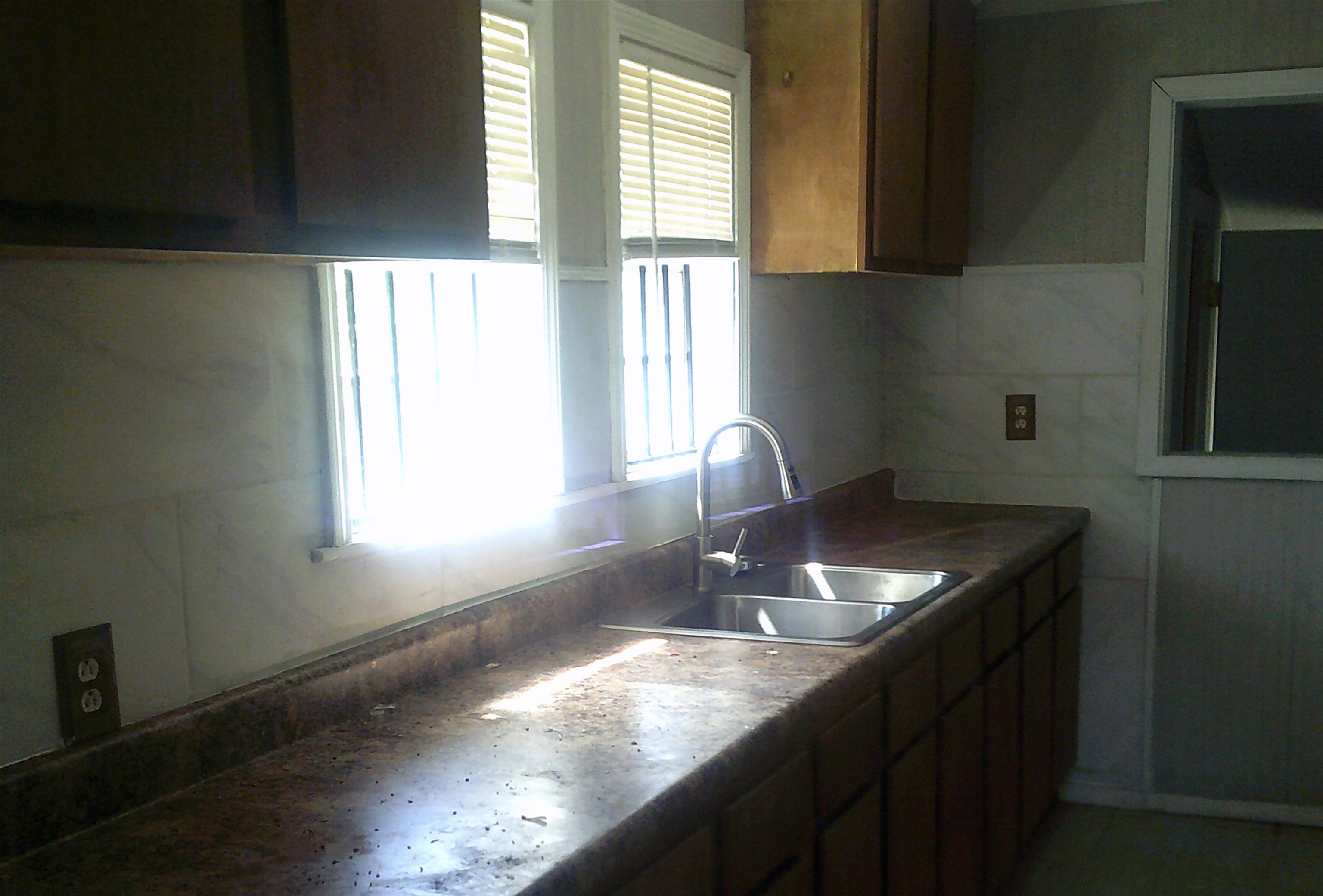 3075 Lotus Road Memphis, TN 38109 - Photo 5 of 14 Kitchen with healthy amount of natural light, tile walls, and dark countertops