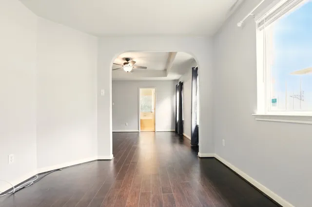 a view of a hallway with wooden floor