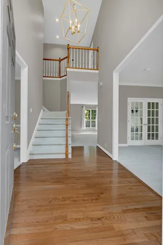 a view of an empty room with a window and a kitchen