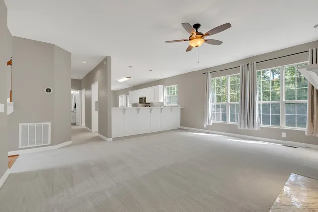 a kitchen with granite countertop white cabinets and a sink