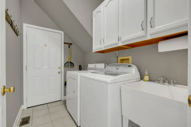 a bathroom with a granite countertop sink a large mirror and a bathtub