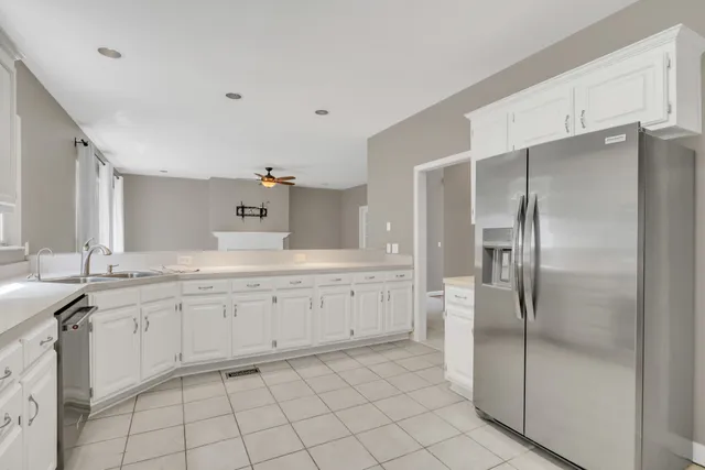 a backyard of a house with trees and outdoor seating