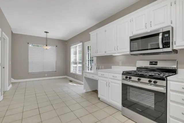 a front view of a house with a tree