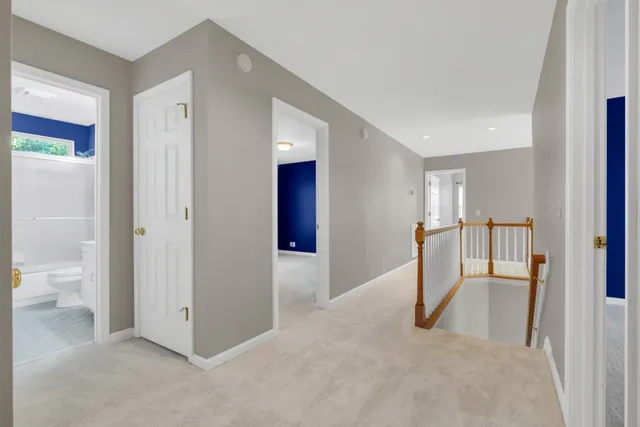 a view of a lake with a yard and large trees