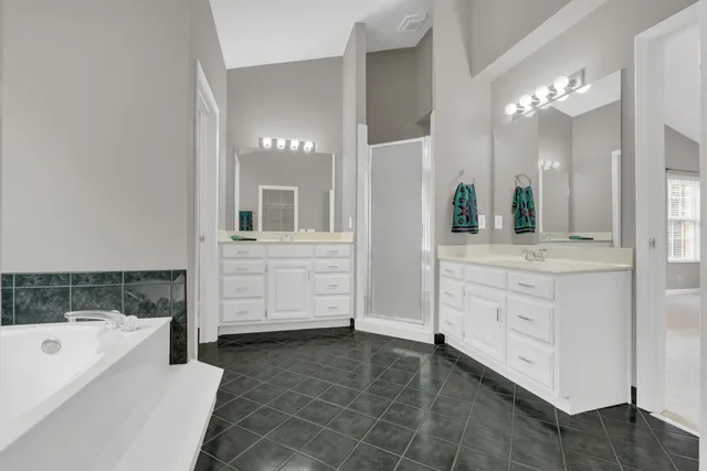 an aerial view of a house with a yard and lake view