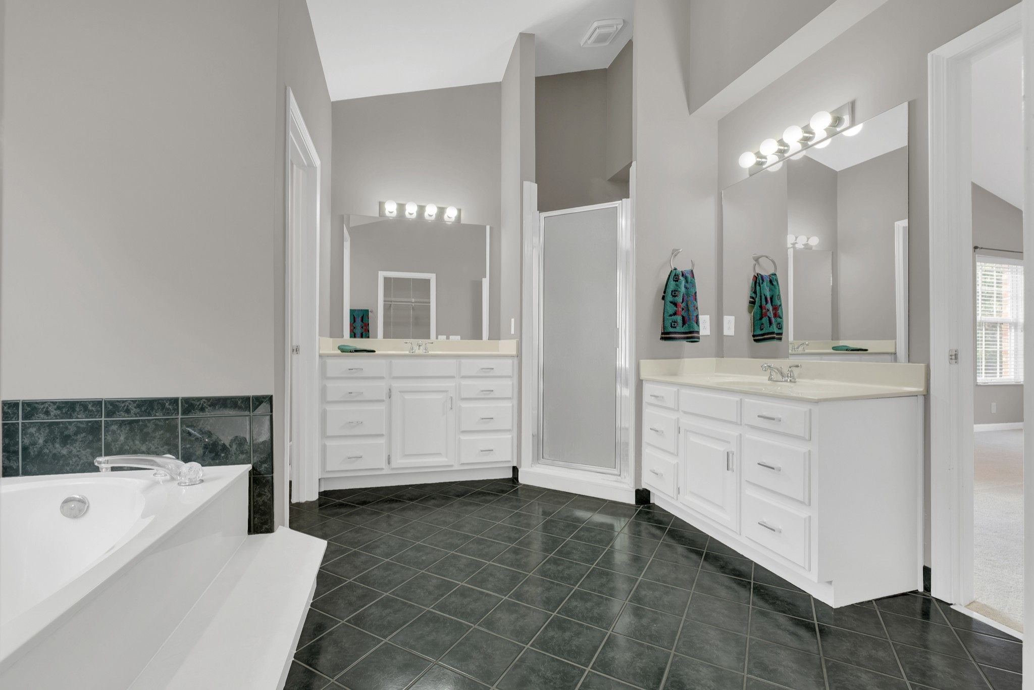 8169 Londonberry Road Nashville, TN 37221 - Photo 45 of 82 a bathroom with a granite countertop sink a large mirror and a bathtub