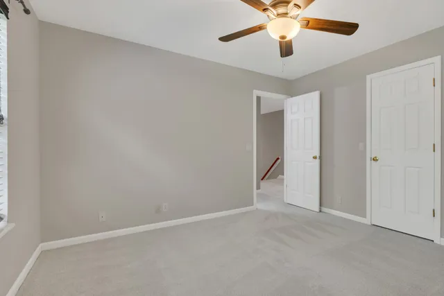 an aerial view of residential houses with outdoor space and trees