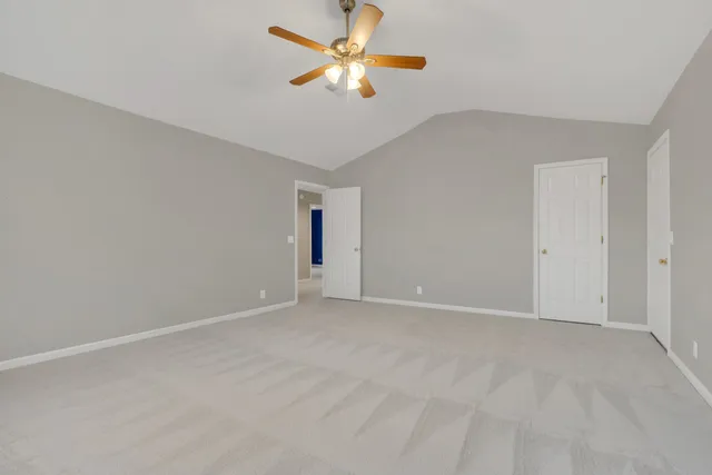 an aerial view of residential houses with outdoor space and trees