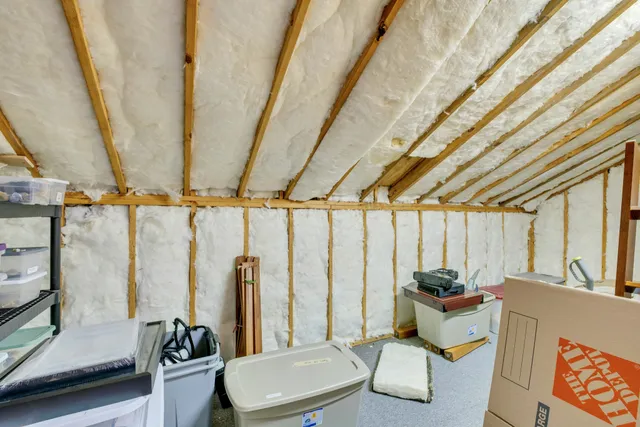 an aerial view of residential houses with outdoor space and trees
