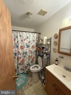 a living room with furniture and a gym machine