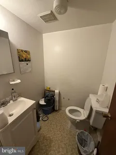 a bed room with a bed and a chair