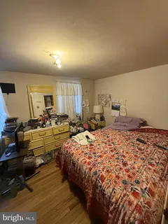 a bedroom with bed and a dresser