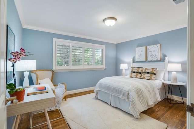 a bedroom with a bed and a table