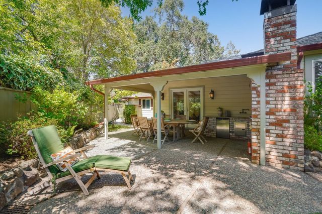 a dining room with furniture a garden and patio