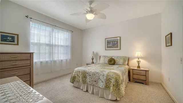 a bedroom with a bed and a lamp with window